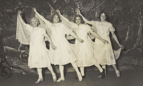 Amateur actors in drag, wearing white dresses and dancing on stage, [between 1910 and 1919?]. Creator: Unknown.