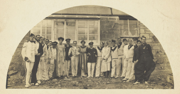 Sailors with men in drag outside a building, [between 1910 and 1919?]. Creator: Unknown.