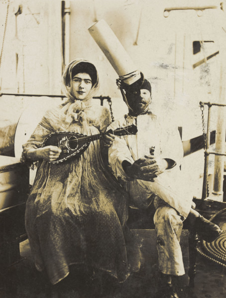 Two sailors (?) on board ship: one in drag is playing a guitar, 1907. Creator: Unknown.