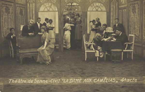 French or Belgian prisoners of war, some in drag, posing on stage during a crowded scene..., (1918?) Creator: Unknown.