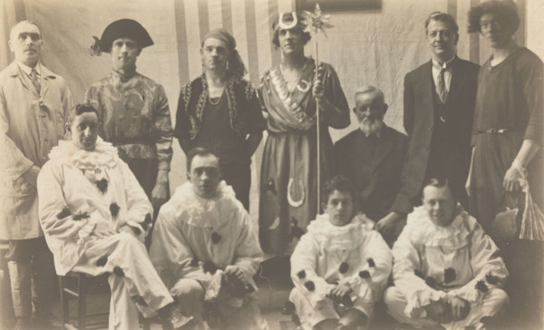 Concert party performers, some in drag, pose for a group portrait, (between 1910 and 1919?). Creator: Unknown.