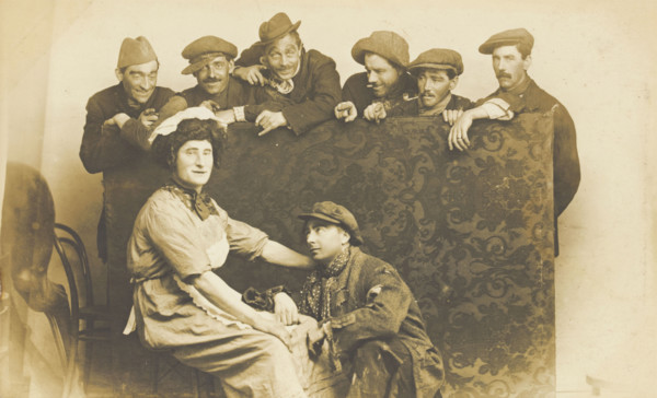 Actors gathered around a man in drag, between 1910 and 1919. Creator: Unknown.