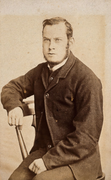 A young man, seated, with an intense expression in his eyes, c1890s. Creator: John Davis.