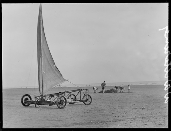 A sand yacht on West Wittering Beach with people digging in the sand, Chichester, West Sussex, 1930s Creator: George R Long.