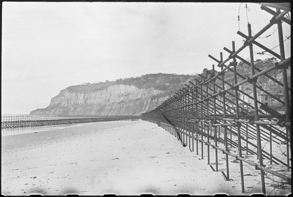 View looking south along the beach at Shanklin, showing Admiralty scaffolding, Isle Of Wight, 1945. Creator: George R Long.