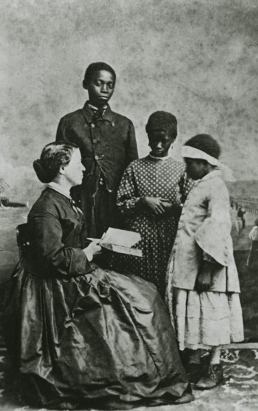 Portrait of teacher Laura M. Towne, a founder of the Penn School, with students..., February 1866. Creator: Unknown.