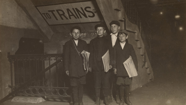 Four Newsies at an Entrance to the Subway, New York City, 1910. Creator: Lewis Wickes Hine.