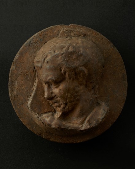 Cast of head of oarsman looking down, with vertical edge of building behind. Creator: Unknown.