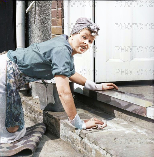 Charlady scrubbing steps, c1955. Creator: Arthur Charles Kirby Ware.