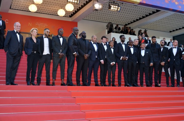 Ladj Ly, Damien Bonnard with the crew of the film 'Les Misérables'