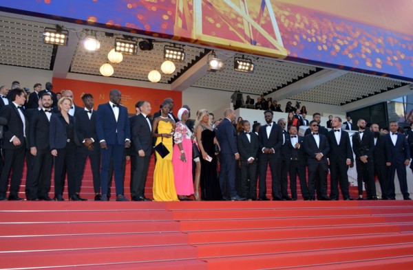 Ladj Ly, Damien Bonnard with the crew of the film 'Les Misérables'