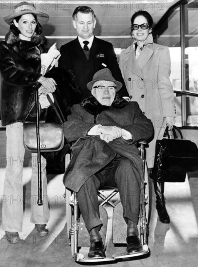 Charlie CHAPLIN in a wheelchair with his wife and daughter Geraldine, London 1973
