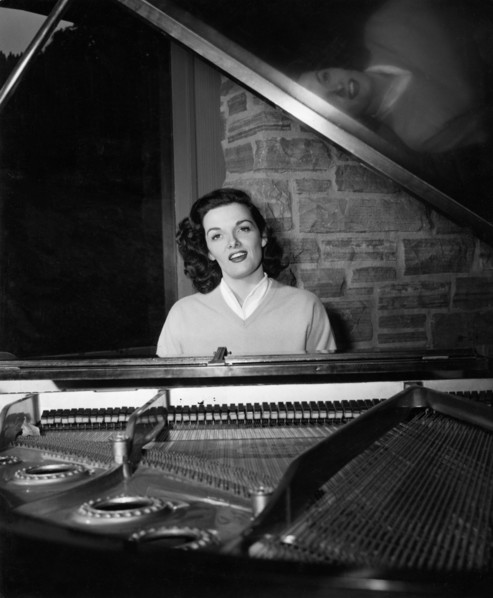 Jane RUSSELL at a grand piano, undated