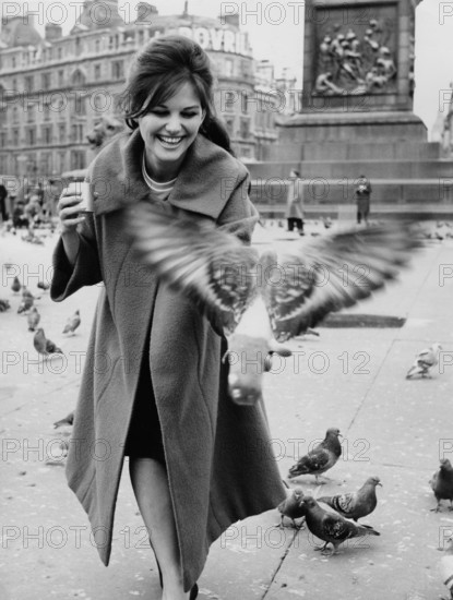 Claudia CARDINALE feeds pigeons in Trafalgar Square, London