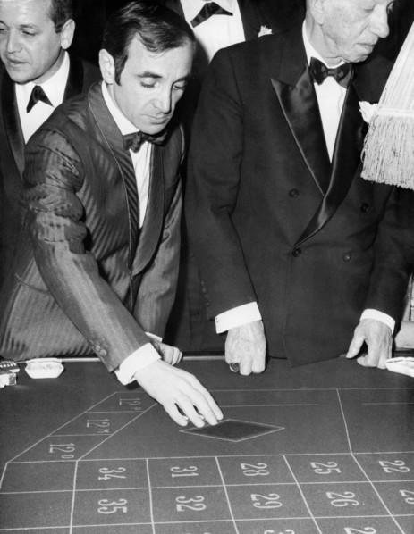 Charles AZNAVOUR at 'Maxim's' playing roulette, Paris circa 1960s