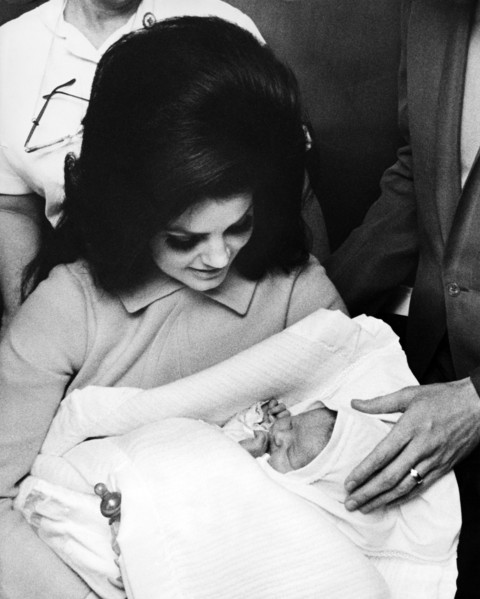 Elvis PRESLEY with his wife and daughter leaving the Baptist Hospital, 1968