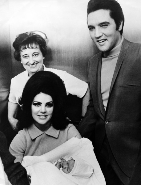 Elvis PRESLEY with his wife and daughter leaving the Baptist Hospital, 1968