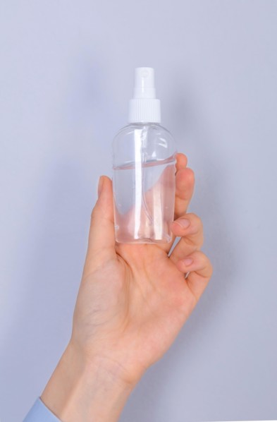 COVID-19 Pandemic Coronavirus. Close up woman hands using hands sanitizer alcohol gel dispenser, against 2019-nCoV. Antiseptic, Hygiene and Healthcare