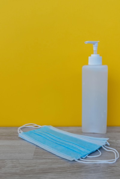 Hand Sanitizer and 3 layer surgical mask - Corona Virus Covid 19 concept - Health and care.