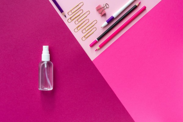 Top view of school stationery and sanitizer and on a multicolored background. Back to school 2020 flat lay and Copy space
