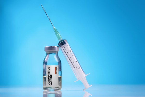Coronavirus Vaccine / Corona virus Vaccine concept with Vial and Syringe on blue background