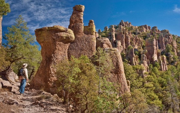 Hiker at rock pinnacles on Hailstone Trail in Chiricahua National Monument, Arizona, USA