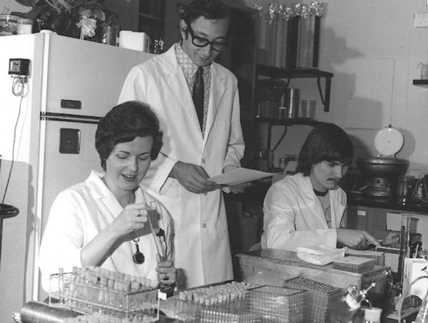 CDC Laboratorians. IMGSETINF, Lab technicians reading and checking serologies to determine presence of influenza A/NJ/8/76 (Swine Flu) and registering antibody rise to the swine influenza virus during...