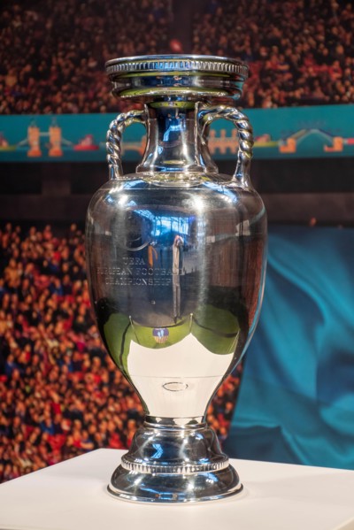 Original UEFA European Championship Trophy with stadium background, vertical