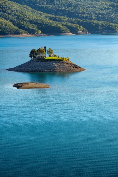 The Saint Michel Chapel and Serre Poncon lake. Saint Michel Bay, Hautes Alpes, Southern French Alps, France