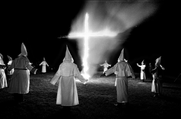 Members of the KKK circle a cross lighting in Rumford Me during rally in the small town Maine town. The Klan had been active in Maine in the 1920's and 30's , This group of Klansmen openly invited the...