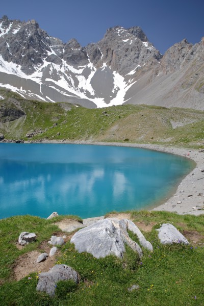 Sainte Anne lake located above Ceillac village after two hours hike, with reflections of mountain range, Queyras Natural Park, Southern Alps, France