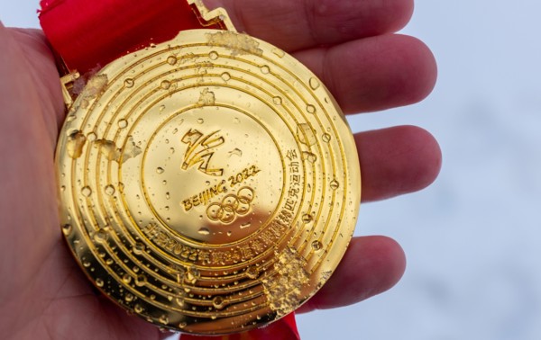 January 4, 2022, Beijing, China. Gold medal of the XXIV Olympic Winter Games in the palm of your hand.