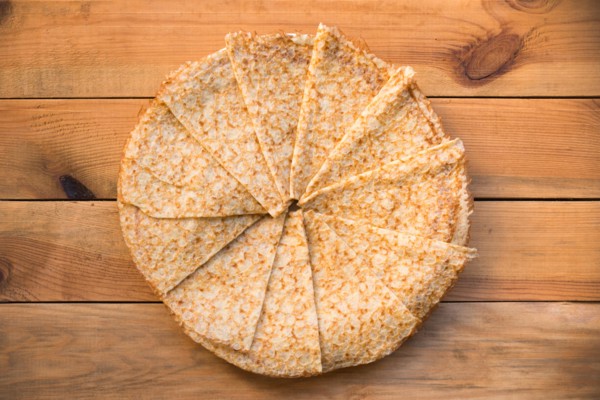 Top view of crepes (french pancakes) folded in circle, on rustic wood background