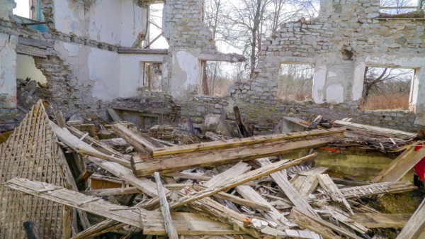 Lots of wooden rubbles on the floor of the house that was damaged during the war in ukraine