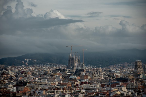 General view of Barcelona city with the Sagrada Familia emerging between the buildings.