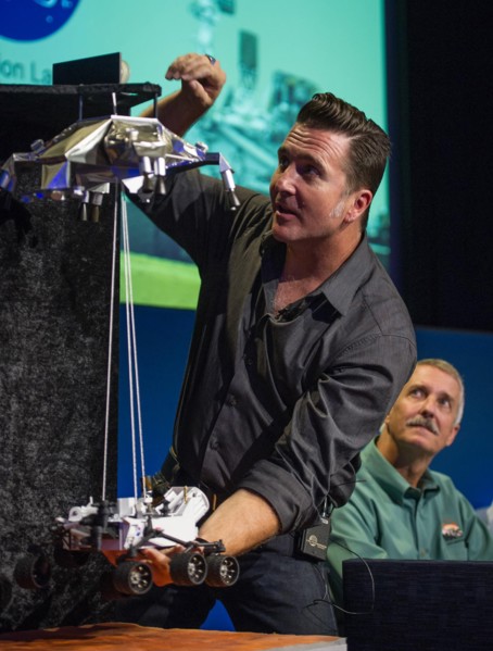 Adam Steltzner, Mars Science Laboratory (MSL) entry, descent and landing phase lead, Jet Propulsion Laboratory, demonstrates how the MSL spacecraft will land the Curiosity rover on Mars during a brief...