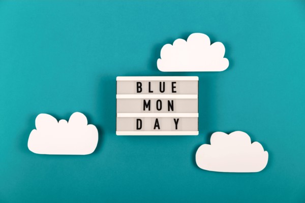 Sad blue Monday lettering with clouds around