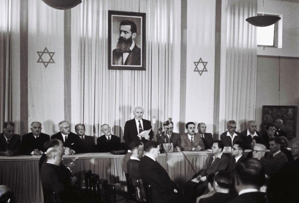 David Ben Gurion, who was to become Israel's first Prime Minister, reads the Israeli Declaration of Independence May 14, 1948 at the museum in Tel Aviv, during the ceremony founding the State of Israe...