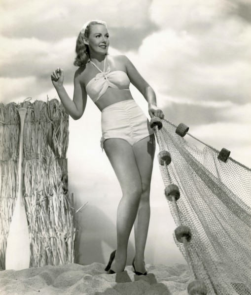 The American actress Angela Green is wearing a white two-piece swimsuit