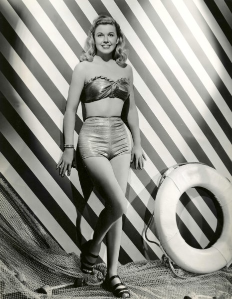 A model wears a swimsuit two-piece 40s