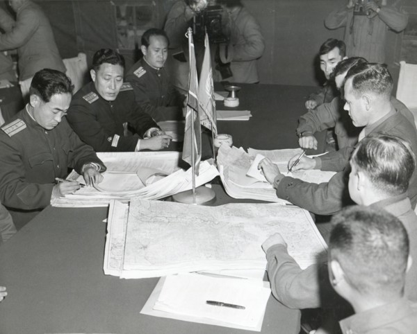 Panmunjom, Korea - Col. James C. Murray, Jr., USMC (rt) and Col Chang Chun San, of the North Korean Communist Army (left) initial maps showing the North and South boundaries of the Demarcation Zone, d...