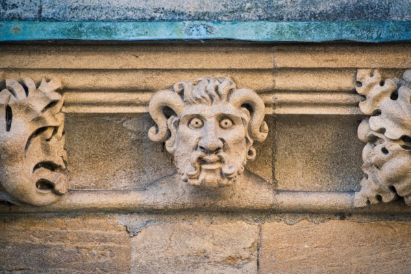 Carved stone horned gargoyle / grotesque on Merton college. Oxford, Oxfordshire, England