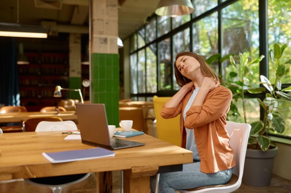 Tired young business woman working at coworking space