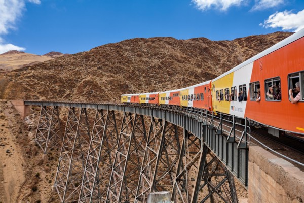 Train to the clouds (tren a las nubes) crossing La Polvorilla bridge in the Altiplano 4.200 meters/13800 feet high, Salta Province, Argentina