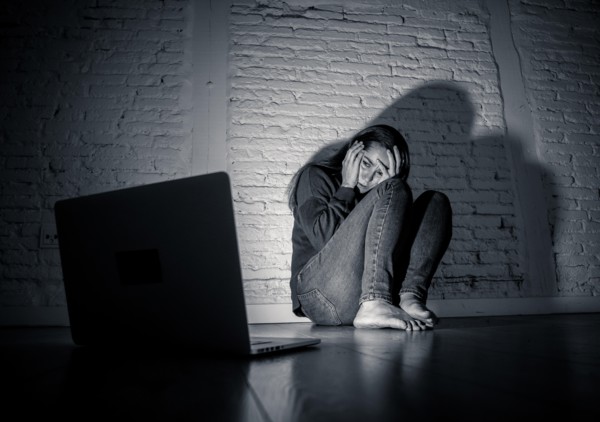 Woman suffering Internet cyber bullying