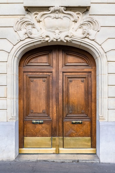 Paris, an ancient wooden door, beautiful facade in the 11e arrondissement