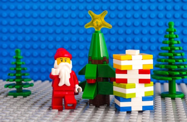 Tambov, Russian Federation - November 06, 2017 Lego Santa Claus and stack of presents near christmas tree. Studio shot.