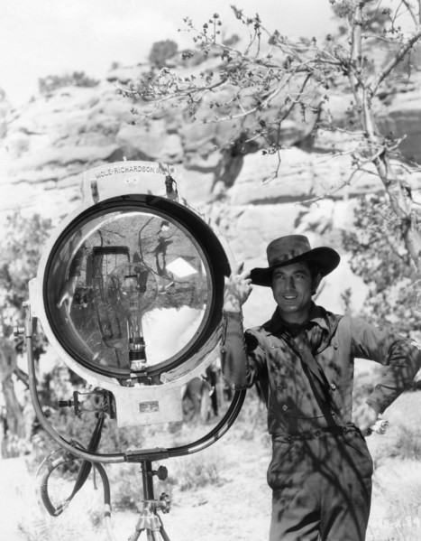 JOHNNY MACK BROWN publicity pose on set location candid next to Mole-Richardson movie light during location filming of  BILLY THE KID 1930 director KING VIDOR book Walter Noble Burns dialogue Laurence...