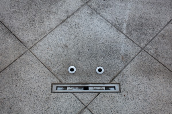 Details in a floor resemble a face in an example of pareidolia. Tokyo, Japan.