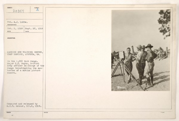 Major R.S. Mayne, a British Army officer, is seen investigating a motion picture camera at the Machine Gun Training Center in Camp Hancock, Augusta, Georgia. This image documents the military's intere...